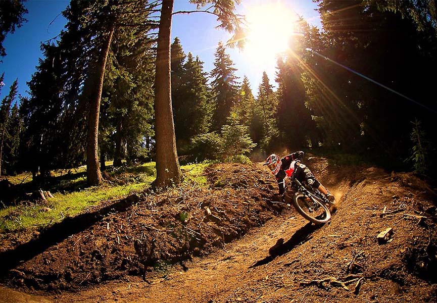 The cyclist is engaged in dirt jumping