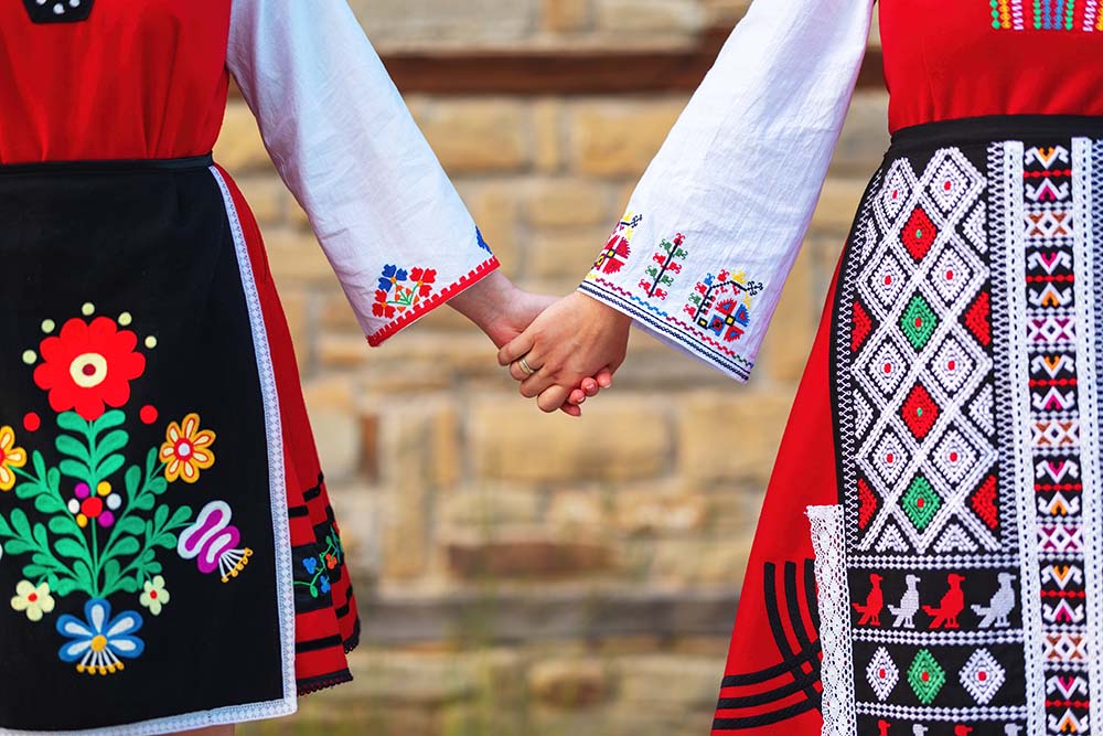 Girls in traditional Bulgarian ethnic costumes with folk embroidery