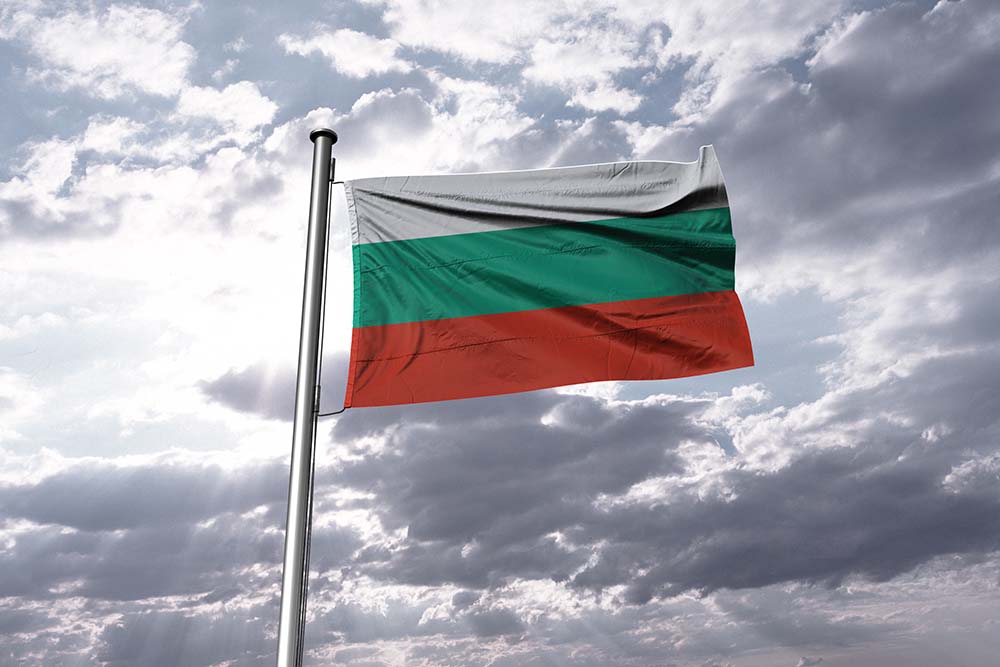 Bulgarian flag against a cloudy sky.