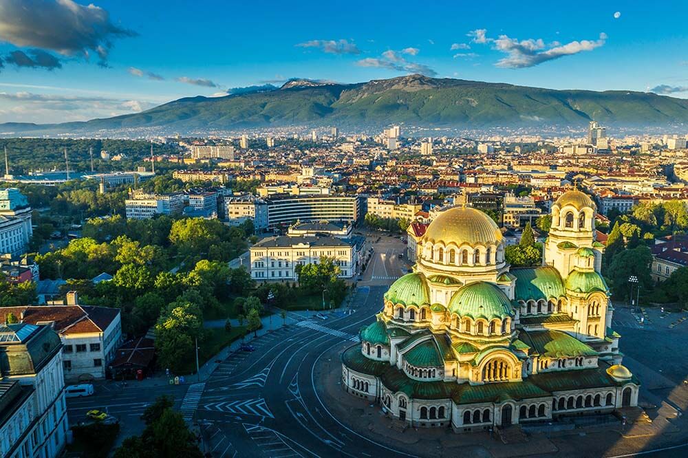 Aerial view of Sofia with Alexander Nevsky Cathedral golden domes and clear sky city landscape