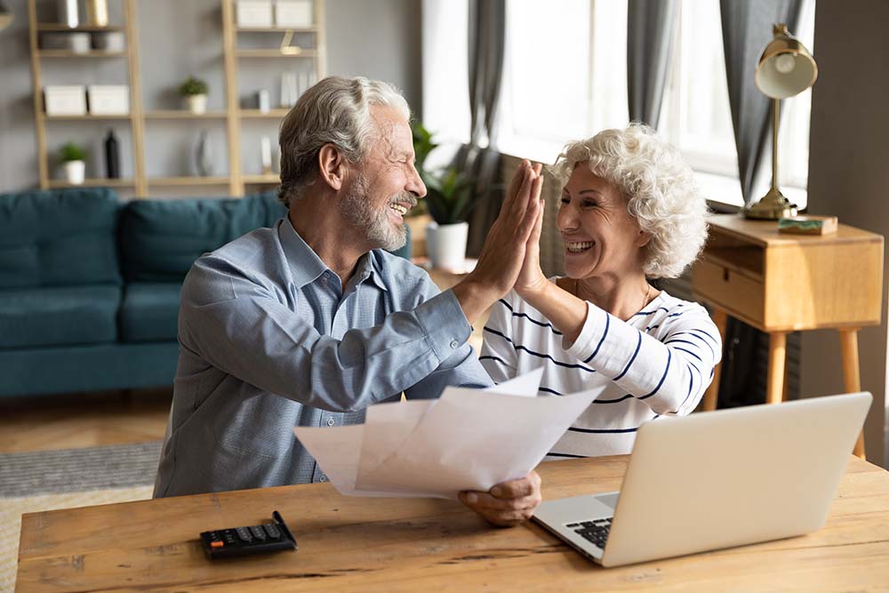 Calculating additional property purchase costs together Couple collaboratively calculating additional property purchase costs and preparing documents