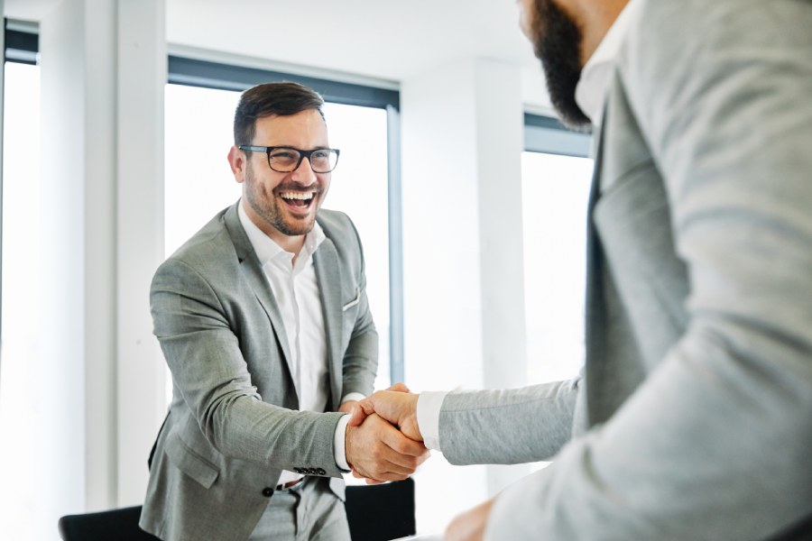 Men shake hands, finalizing the structured process of property purchase in Bulgaria by a Belgian citizen.